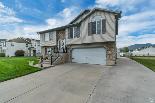 1874 W 180 S, Orem, UT 84059 - view of front of house featuring concrete driveway, an attached garage, brick siding, and a residential view