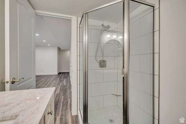 2240 S Lorin Cir W, Ogden, UT 84401 - bathroom with wood finished floors, a stall shower, vanity, baseboards, and recessed lighting