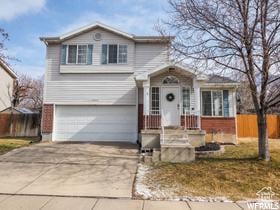 2240 S Lorin Cir W, Ogden, UT 84401 - traditional-style house featuring an attached garage and driveway