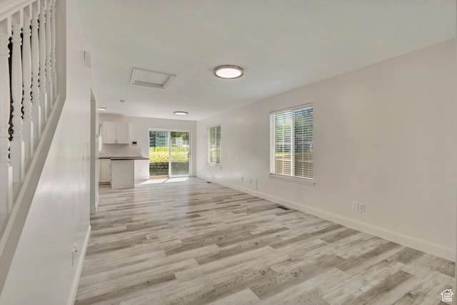 2240 S Lorin Cir W, Ogden, UT 84401 - unfurnished living room featuring light wood-style floors, plenty of natural light, and baseboards