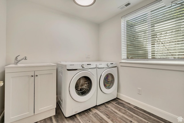 2240 S Lorin Cir W, Ogden, UT 84401 - laundry room featuring washing machine and dryer, wood finished floors, baseboards, and cabinet space