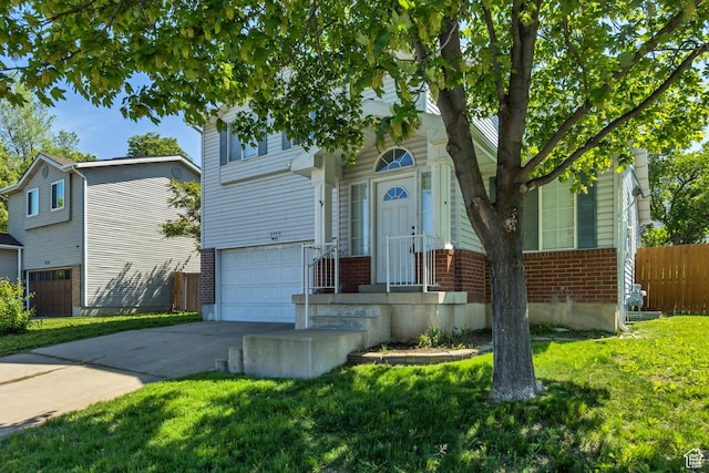 2240 S Lorin Cir W, Ogden, UT 84401 - view of front of home with brick siding, driveway, and an attached garage