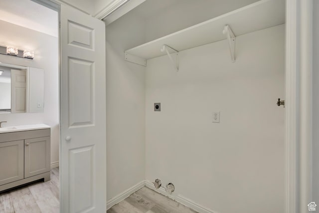 2240 S Lorin Cir W, Ogden, UT 84401 - laundry area with electric dryer hookup, light wood finished floors, and baseboards