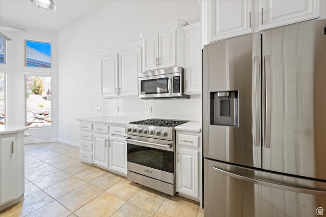 42 N 1100 W, St George, UT 84770 - kitchen featuring stainless steel appliances, light countertops, white cabinets, and light tile patterned floors