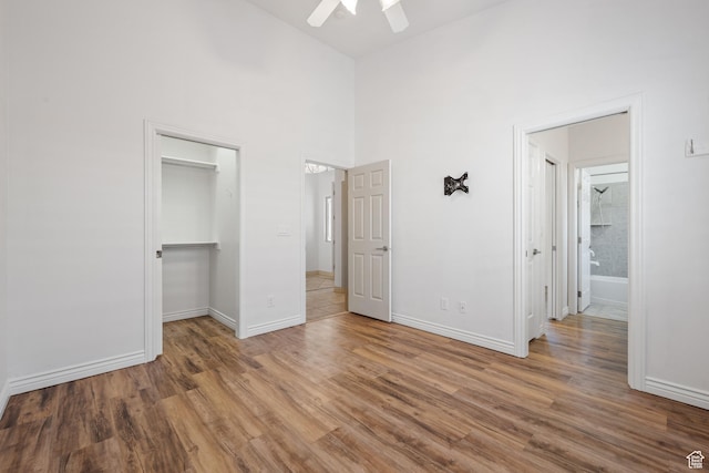 42 N 1100 W, St George, UT 84770 - unfurnished bedroom featuring wood finished floors, baseboards, a walk in closet, a high ceiling, and a ceiling fan