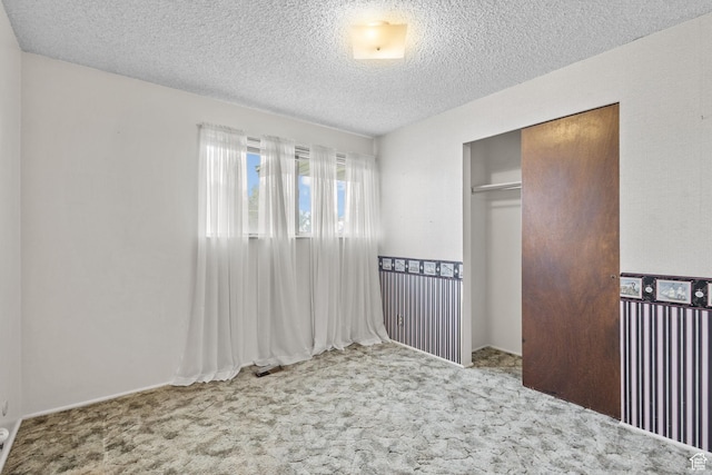 9216 S 2700 W, West Jordan, UT 84088 - unfurnished bedroom featuring carpet flooring, a closet, and a textured ceiling