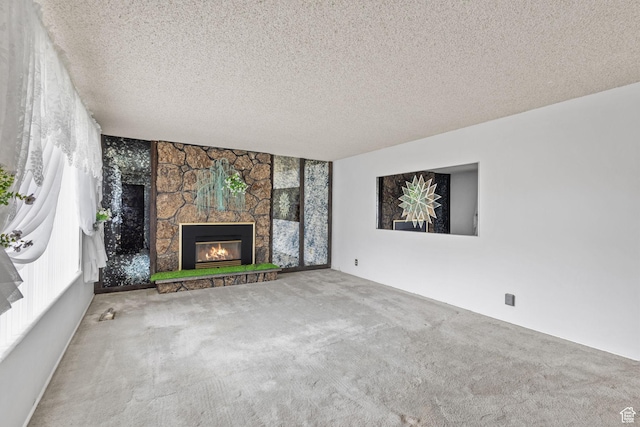 9216 S 2700 W, West Jordan, UT 84088 - unfurnished living room featuring carpet floors, a fireplace, and a textured ceiling