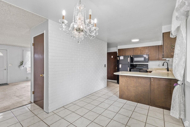 9216 S 2700 W, West Jordan, UT 84088 - kitchen with black appliances, light tile patterned flooring, a sink, light countertops, and a chandelier
