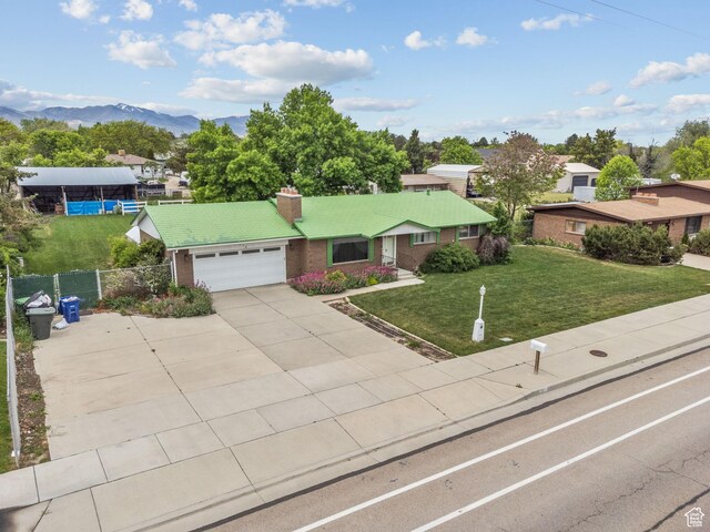 9216 S 2700 W, West Jordan, UT 84088 - ranch-style home with a garage, a chimney, driveway, brick siding, and a mountain view