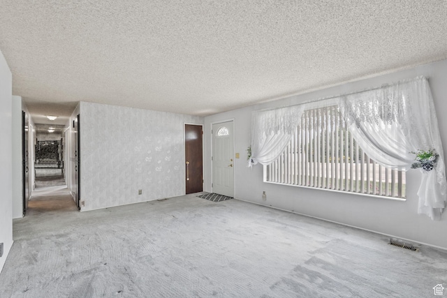 9216 S 2700 W, West Jordan, UT 84088 - unfurnished living room featuring carpet floors and a textured ceiling