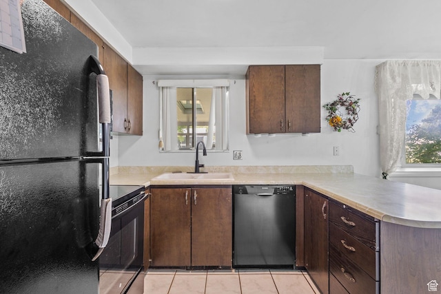 9216 S 2700 W, West Jordan, UT 84088 - kitchen with black appliances, a sink, light countertops, light tile patterned flooring, and a peninsula