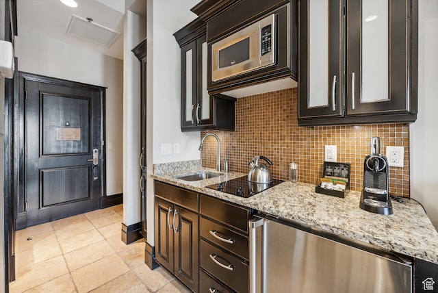 2100 Frostwood Blvd Unit 5130, Snyderville, UT 84098 - kitchen featuring a sink, stainless steel microwave, decorative backsplash, black electric cooktop, and light stone counters