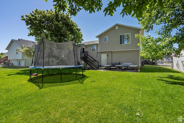 3916 W 4800 S, Roy, UT 84067 - rear view of property featuring a trampoline, stairs, and a patio