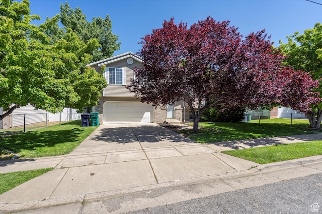 3916 W 4800 S, Roy, UT 84067 - view of property hidden behind natural elements featuring a garage and driveway