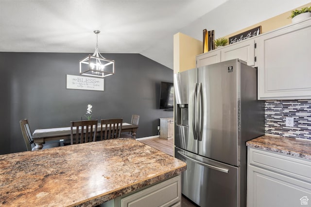 3916 W 4800 S, Roy, UT 84067 - kitchen with stainless steel refrigerator with ice dispenser, decorative backsplash, a chandelier, vaulted ceiling, and white cabinetry