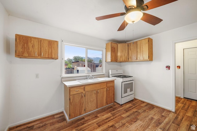 611 E 500 N, Spanish Fork, UT 84660 - kitchen with white range with gas cooktop, a sink, light countertops, and wood finished floors