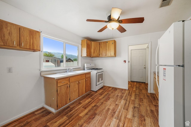 611 E 500 N, Spanish Fork, UT 84660 - kitchen with white appliances, wood finished floors, brown cabinets, and a ceiling fan