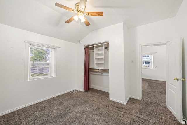 611 E 500 N, Spanish Fork, UT 84660 - unfurnished bedroom featuring dark carpet, multiple windows, vaulted ceiling, baseboards, and a ceiling fan