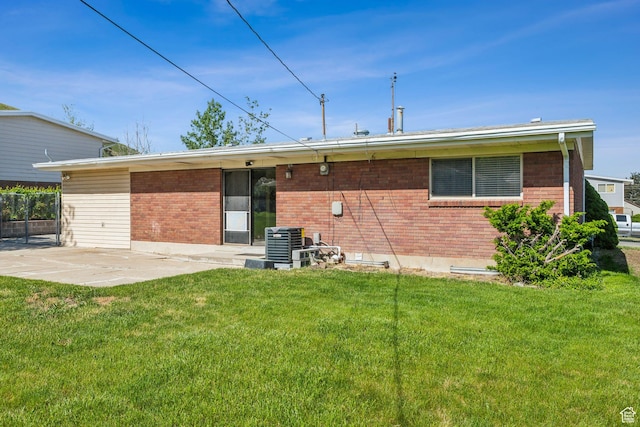 295 S 2nd St, Tooele, UT 84074 - back of property with a patio, brick siding, a yard, and central air condition unit