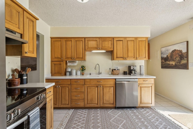 295 S 2nd St, Tooele, UT 84074 - kitchen featuring stainless steel appliances, a sink, exhaust hood, light countertops, and light tile patterned floors