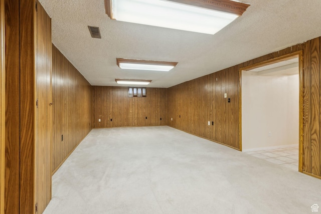 295 S 2nd St, Tooele, UT 84074 - finished below grade area with a textured ceiling, light colored carpet, and wooden walls