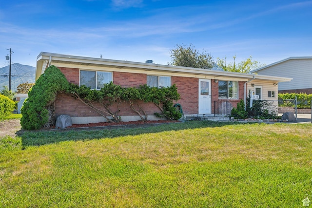 295 S 2nd St, Tooele, UT 84074 - ranch-style home with brick siding and a front yard