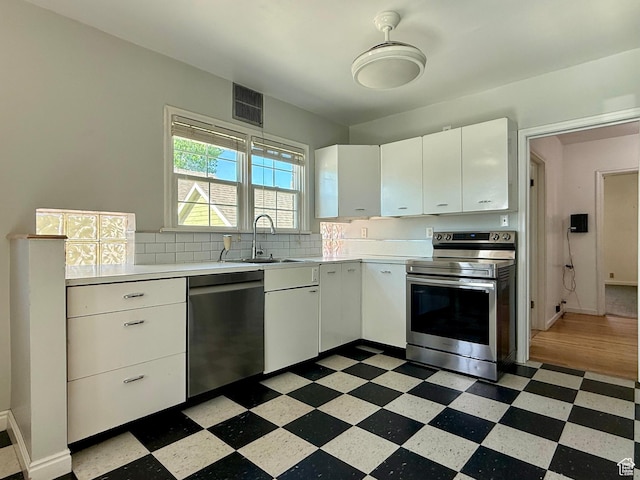 169 N State St, Roosevelt, UT 84066 - kitchen with stainless steel appliances, dark floors, light countertops, and a sink