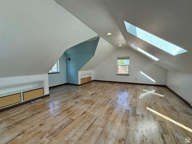 169 N State St, Roosevelt, UT 84066 - bonus room with a skylight, wood finished floors, vaulted ceiling, and baseboards