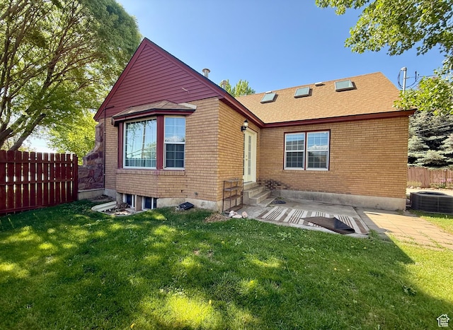 169 N State St, Roosevelt, UT 84066 - back of house featuring entry steps, central AC, a patio area, brick siding, and roof with shingles