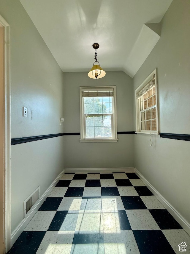 169 N State St, Roosevelt, UT 84066 - unfurnished dining area with tile patterned floors, baseboards, and vaulted ceiling