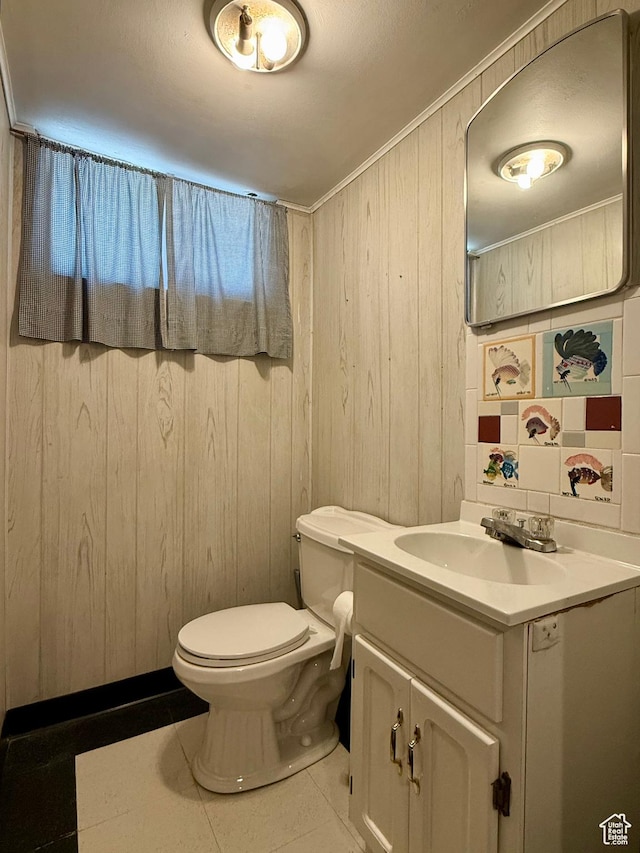 169 N State St, Roosevelt, UT 84066 - bathroom featuring vanity, tile patterned flooring, toilet, and wooden walls