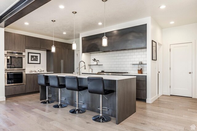 260 W 500 N Unit 4, Salt Lake City, UT 84103 - kitchen featuring modern cabinets, appliances with stainless steel finishes, a kitchen bar, and recessed lighting