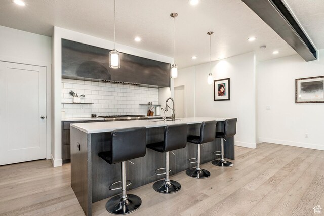 260 W 500 N Unit 4, Salt Lake City, UT 84103 - kitchen featuring a sink, light wood-style flooring, decorative backsplash, light countertops, and recessed lighting