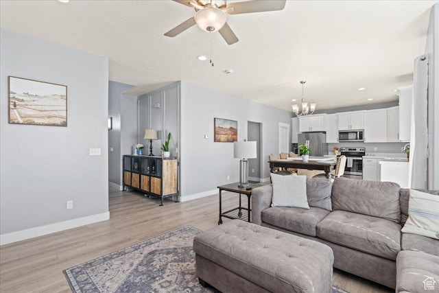 3624 N Annabell St, Eagle Mountain, UT 84005 - living room featuring ceiling fan, a chandelier, light wood-style flooring, baseboards, and recessed lighting