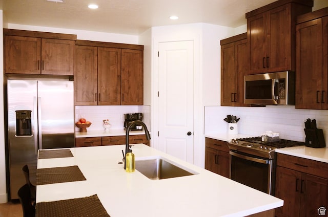 1376 Rustico, Washington, UT 84780 - kitchen featuring appliances with stainless steel finishes, a sink, tasteful backsplash, light countertops, and recessed lighting
