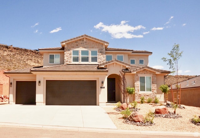 1376 Rustico, Washington, UT 84780 - view of front of house with a tile roof, stone siding, stucco siding, driveway, and an attached garage