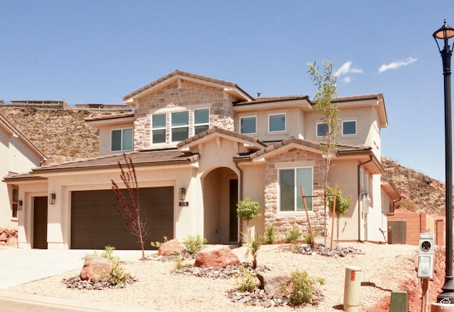 1376 Rustico, Washington, UT 84780 - view of front of home with stone siding, stucco siding, a garage, and concrete driveway