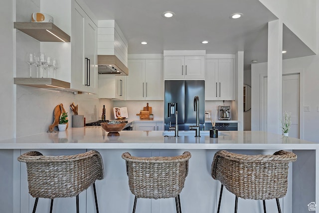 1504 Lake Front Ct, Park City, UT 84098 - kitchen with stainless steel refrigerator with ice dispenser, a peninsula, light countertops, recessed lighting, and white cabinetry