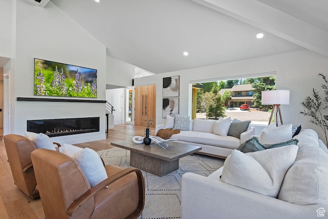 1504 Lake Front Ct, Park City, UT 84098 - living area featuring high vaulted ceiling, light wood-style flooring, a glass covered fireplace, recessed lighting, and beam ceiling