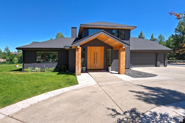 1504 Lake Front Ct, Park City, UT 84098 - modern home with concrete driveway, an attached garage, a front lawn, a chimney, and a shingled roof