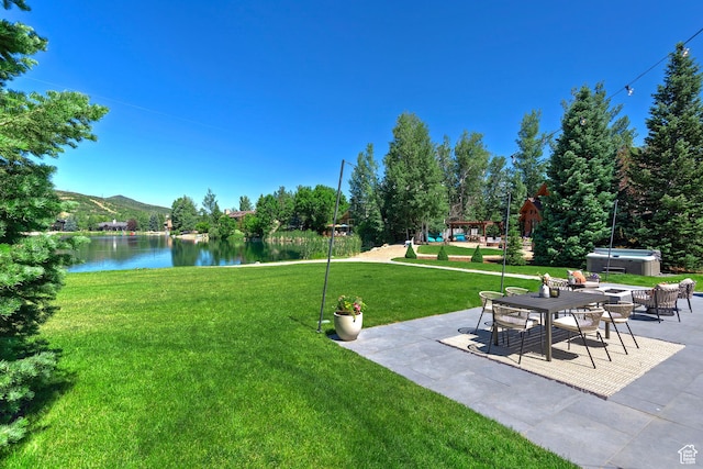 1504 Lake Front Ct, Park City, UT 84098 - view of green lawn featuring a hot tub, a patio area, and a water and mountain view