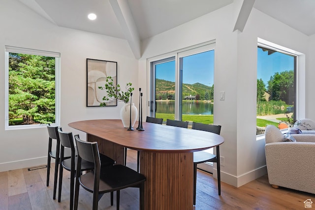 1504 Lake Front Ct, Park City, UT 84098 - dining room featuring baseboards, wood-type flooring, a water view, and vaulted ceiling