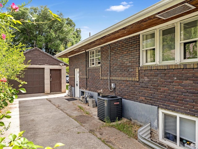 628 E 420 N, Provo, UT 84606 - view of home's exterior featuring central AC, brick siding, an outdoor structure, and a detached garage