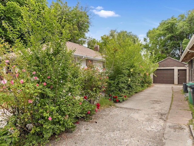 628 E 420 N, Provo, UT 84606 - view of side of home with an outbuilding, a detached garage, and a chimney