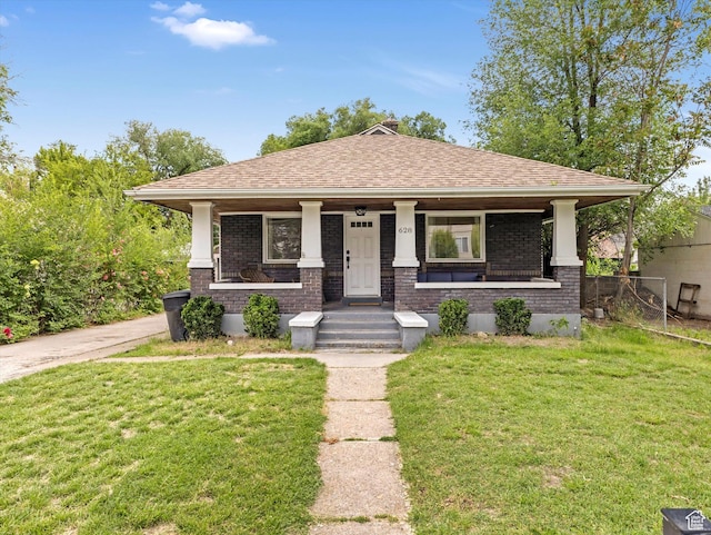 628 E 420 N, Provo, UT 84606 - view of front of house featuring covered porch, brick siding, a front lawn, and a shingled roof