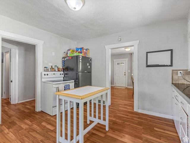 628 E 420 N, Provo, UT 84606 - kitchen with electric stove, freestanding refrigerator, light wood-style floors, white cabinetry, and baseboards