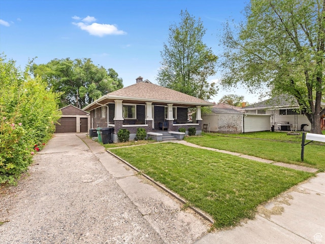 628 E 420 N, Provo, UT 84606 - view of front facade with an outdoor structure, a detached garage, a porch, a front lawn, and a chimney