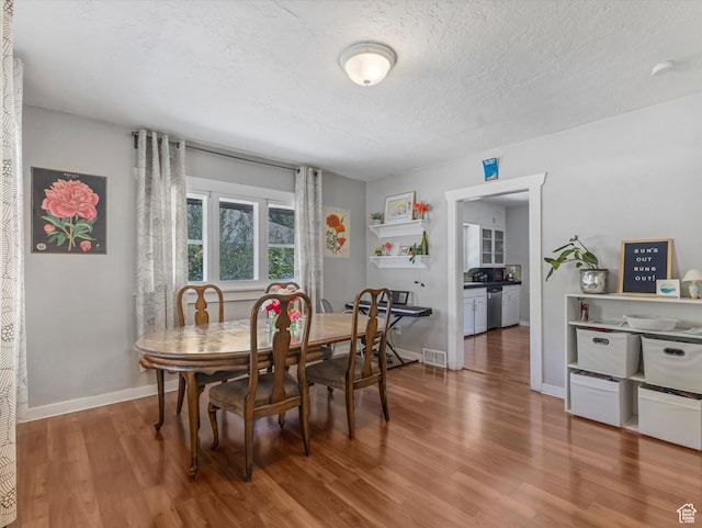 628 E 420 N, Provo, UT 84606 - dining space with wood finished floors, a textured ceiling, and baseboards