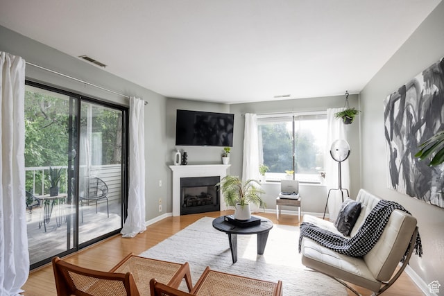 2660 E 3300 S Unit A-21, Salt Lake City, UT 84109 - living area featuring wood finished floors, a fireplace, and baseboards