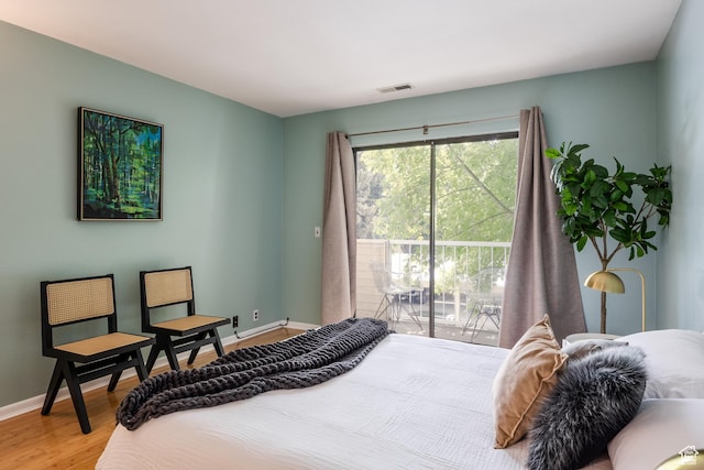 2660 E 3300 S Unit A-21, Salt Lake City, UT 84109 - bedroom with access to exterior, wood finished floors, and baseboards